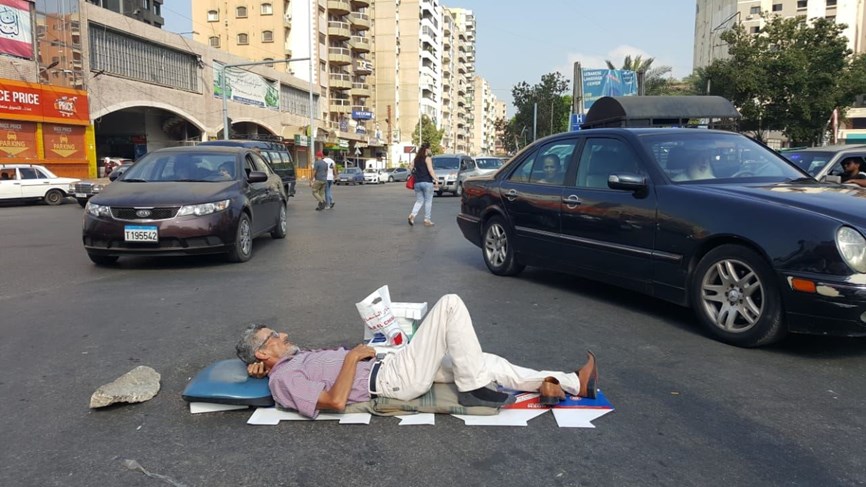 بالصورة/ إفترش الارض وسط ساحة النور في طرابلس احتجاجاً على الاوضاع المعيشية